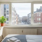 Bright urban bedroom with desk and window view; Rent a Room Cheap Near Me: 2026 Guide to Affordable Housing.