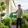A man applying balcony vegetable gardening tips for renters to grow fresh tomatoes and herbs in small pots.