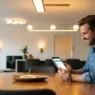 Calculating the average light bill for 2 bedroom apartment on a tablet in a modern, bright home.